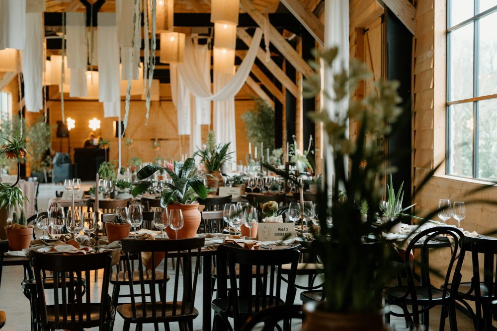 Event venue set with potted plants on the tables | Plants Alive! Event venue with long tables dressed in potted plants and greenery